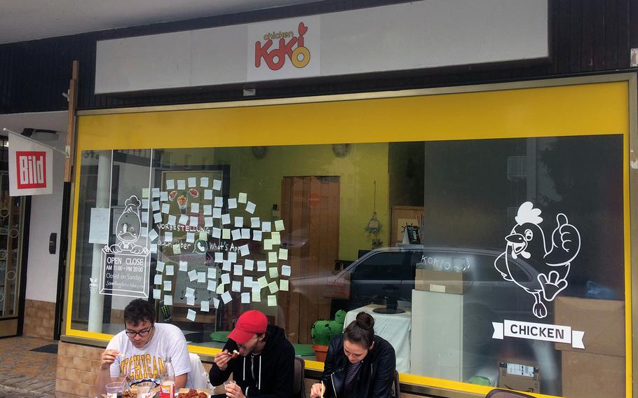Diners eat outside Chicken Kokio in Wiesbaden, Germany. The restaurant - primarily a takeaway joint - features delicious and crispy Korean fried chicken, with or without sauce, and side dishes.