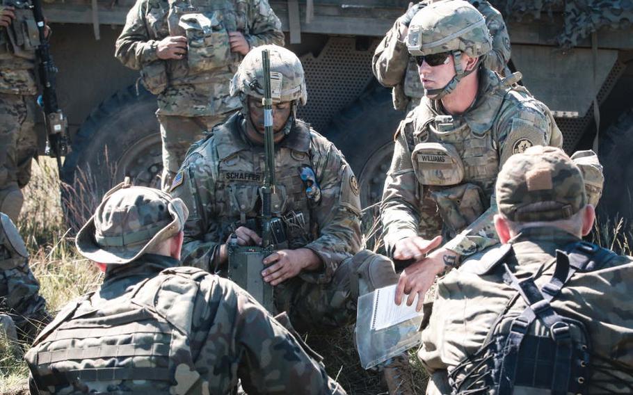 Army Pvt. Jacob Williams, right, with the 1st Squadron, 2nd Cavalry Regiment, teaches Polish soldiers how to use a Single Channel Ground and Airborne Radio System during the Saber Strike exercise at Wyreby, Poland, on June 7, 2018. The U.S. Senate approved a measure last week that would call on the Pentagon to consider the feasibility of permanently deploying U.S. troops to Poland to counter Russian aggression.