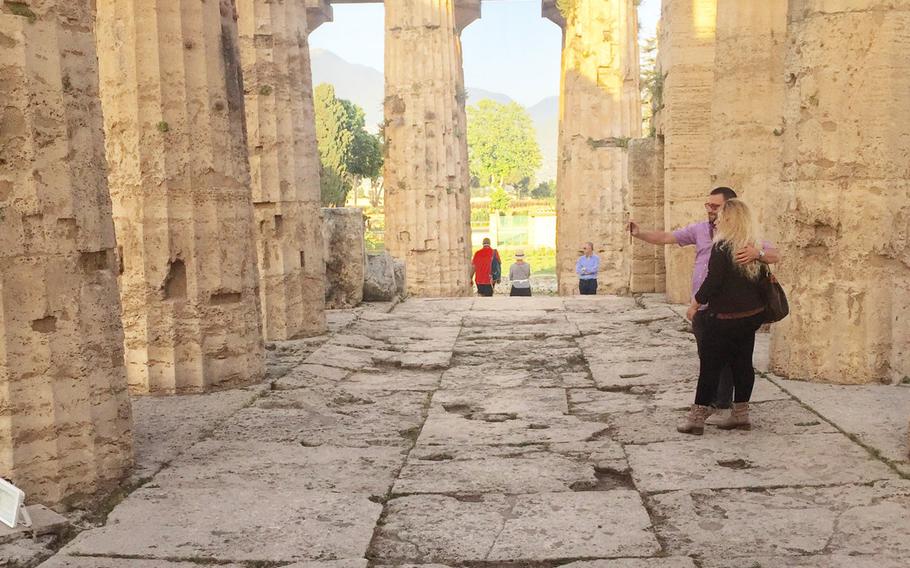 Visitors explore the second temple of Hera at Paestum's Greek ruins in Salerno, Italy.