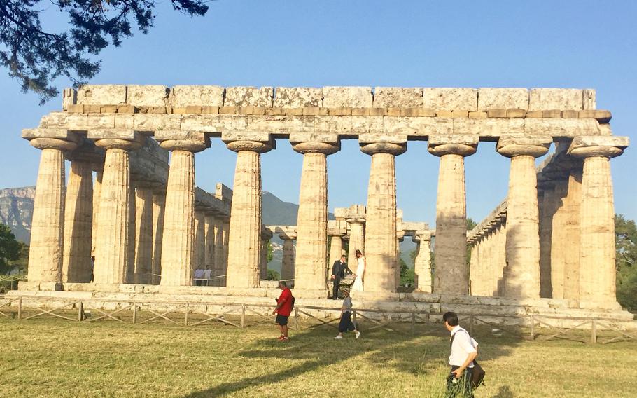 A newly married couple take wedding photos at the first temple of Hera, built about 550 B.C. Three of the best-preserved Greek temples can be seen at the Paestum ruins in Salerno, Italy.