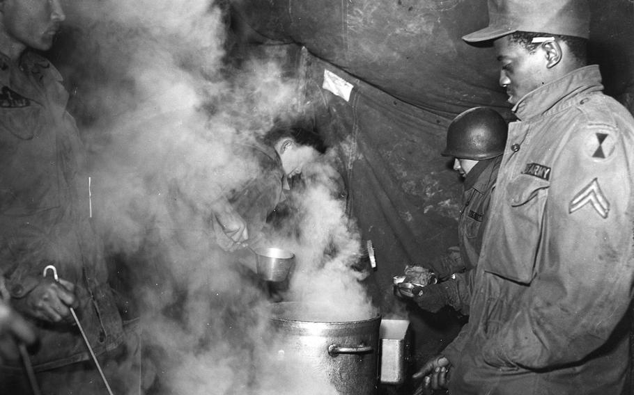 Soldiers grab dinner in South Korea, May 13, 1955.