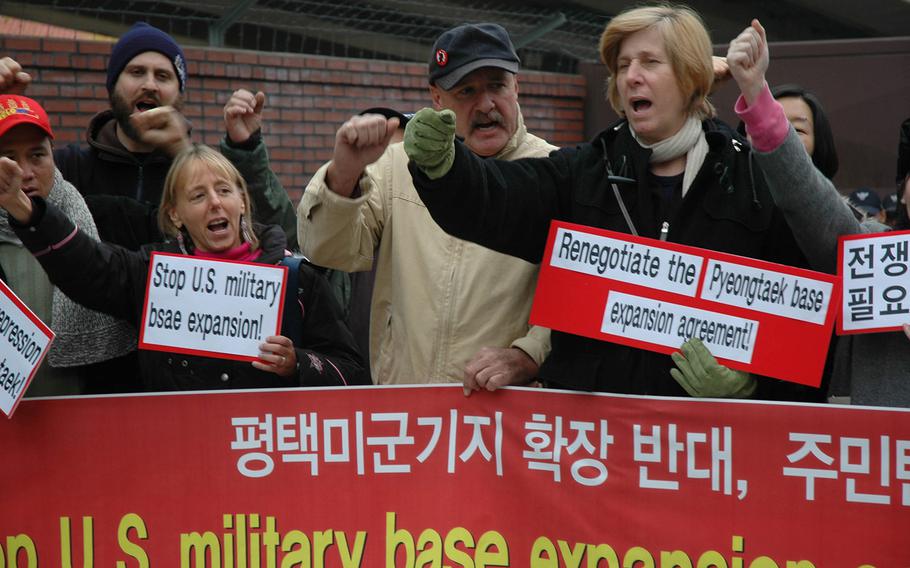 Cindy Sheehan, center, and about two dozen protesters stand outside Yongsan Garrison in Seoul, South Korea, and denounce the U.S. military's expansion of Camp Humphreys, Nov. 21, 2006.