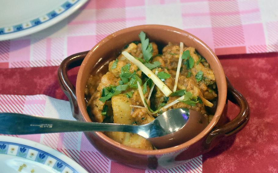Allu gobhi, a dish featuring vegetables such as potatoes and cauliflower, is offered at Ristorante Shahi Qila in Sacile, Italy.