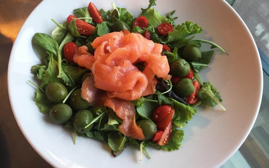Raw salmon salad with green olives and juicy, sliced tomatoes. Grangusto's diverse menu includes many healthy seafood dishes.