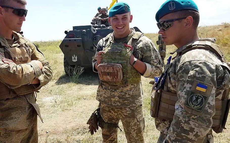Ukrainian marine Cpt. Alexander Tonenchuk, right, the executive officer of 1st Marine Battalion, speaks to his Marines during training with American Marines at Exercise Sea Breeze, Saturday, July 14, 2018. 