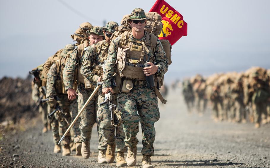 U.S. Marines of Charlie Company, 1st Battalion, 3rd Marine Regiment, march to the next range during Rim of Pacific drills at Pohakuloa Training Area, Hawaii, Sunday, July 15, 2018.