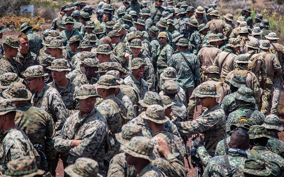 U.S., Chilean, Philippine and South Korean troops await marching orders during the Rim of Pacific exercise at Pohakuloa Training Area, Hawaii, Sunday, July 15, 2018.