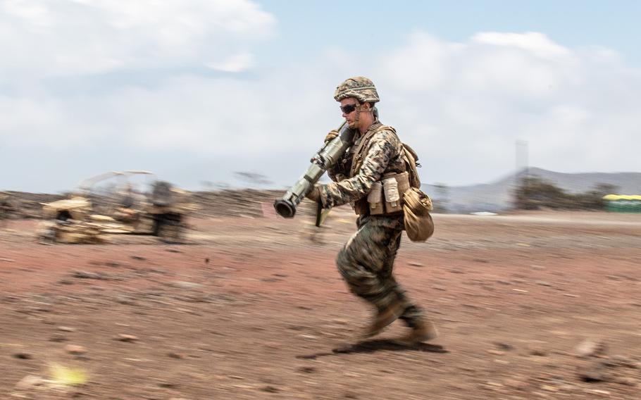 A U.S. Marine rushes down a range with a simulated AT-4 anti-tank rocket launcher during the Rim of the Pacific exercise at Pohakuloa Training Area, Hawaii, Wednesday, July 18, 2018.
