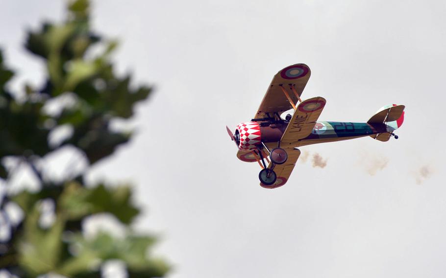 A biplane flies over Oise-Aisne American Cemetery at Seringes-et-Nesles, France, during a ceremony marking the centennial of the World War I Oise-Aisne Offensive, Saturday, July 28, 2018.