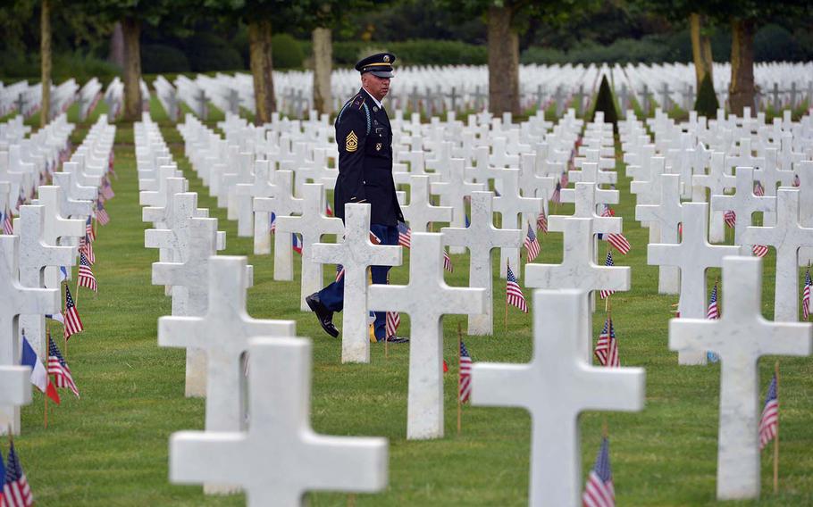 Command Sgt. Maj. Terry White, 1st Battalion, 167th Infantry Regiment, walks through the graves at Oise-Aisne American Cemetery at Seringes-et-Nesles, France, after the ceremony marking the centennial of the Oise-Aisne Offensive, Saturday, July 28, 2018. 
