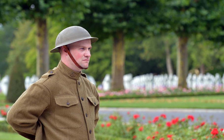 Dressed in a World War I-style uniform, Cpl. John Koenig of the 42nd Infantry Division, stands near the flag pole at Oise-Aisne American Cemetery at Seringes-et-Nesles, France. French and Americans marked the 100th anniversary of the Oise-Aisne Offensive at a ceremony at the cemetery.