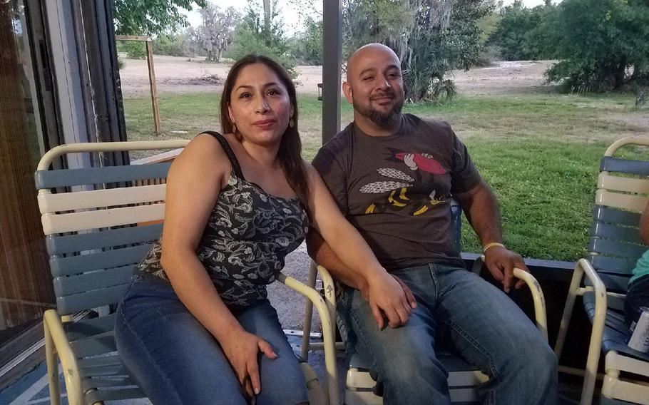 Alejandra Juarez, left, and her husband of 20 years Temo Juarez, an Iraq combat veteran, enjoy a barbecue with friends in April. Alejandra entered the country illegally in 1998 and was deported to Mexico Aug. 3, dividing the family of four.