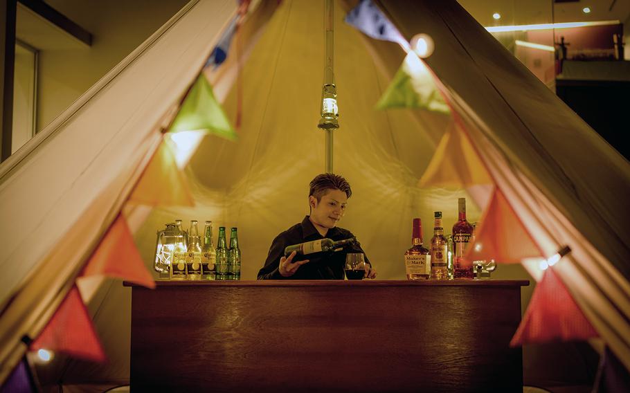 A bartender mixes up a cocktail at Bar Berotti inside of the temporary restaurant Barvelous.