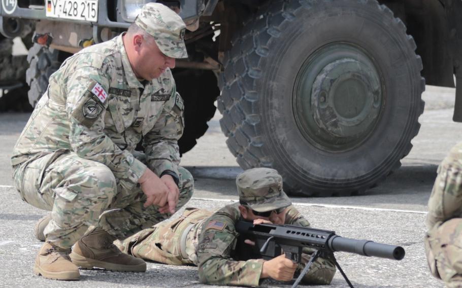 Pfc. Schuyler T. Lopez, an infantryman with the Vilseck, Germany based 2nd Cavalry Regiment, gets familiar with a Georgian PDShP2 anti-materiel rifle prior to the opening ceremonies of Noble Partner at the Vaziani Training Area, Georgia on Aug. 1, 2018. The U.S. military and Georgian Armed Forces have trained and fought together side by side in Iraq and Afghanistan for more than 15 years.