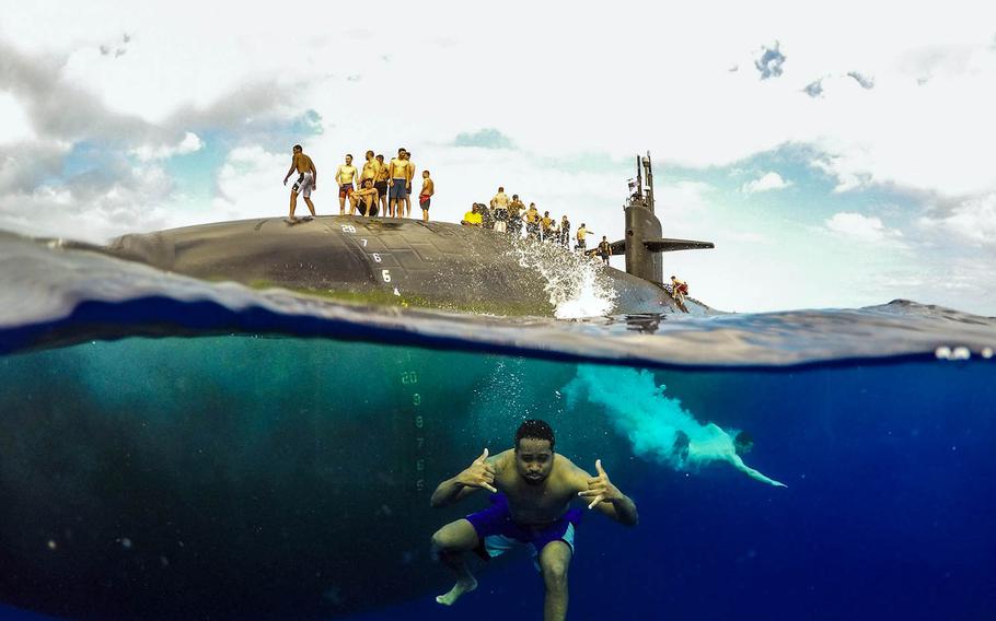 Sailors assigned to Los Angeles-class fast-attack submarine USS Olympia swim in the Pacific Ocean, July 31, 2018.