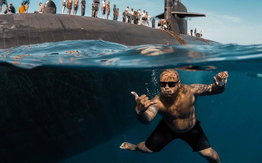 Sailors assigned to Los Angeles-class fast-attack submarine USS Olympia swim in the Pacific Ocean, July 31, 2018.