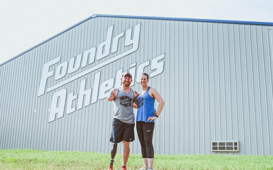 Jared Bullock, a former Green Beret, and his wife Jesica stand outside Foundry Athletics, a gym they opened May 19, 2018, in Carterville, Ill.