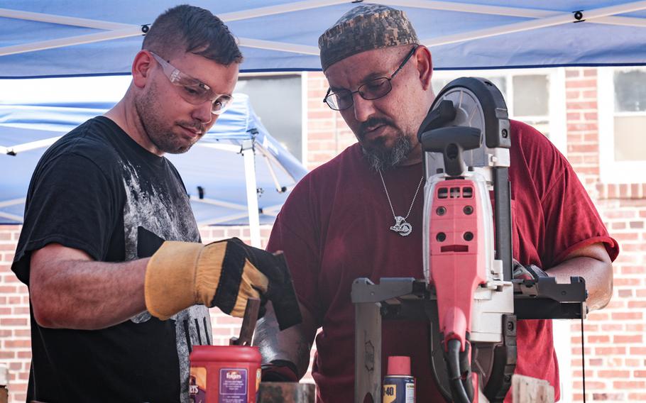 Adam Porras, right, gives some forging advice to Army Reserve Sgt. Eric Lang on Aug. 11, 2018 as part of Recovery Forge. Military veterans Adam and Donna Porras run Recovery Forge in Lorton, Va. The program teaches forging skills to servicemembers, veterans and first responders.