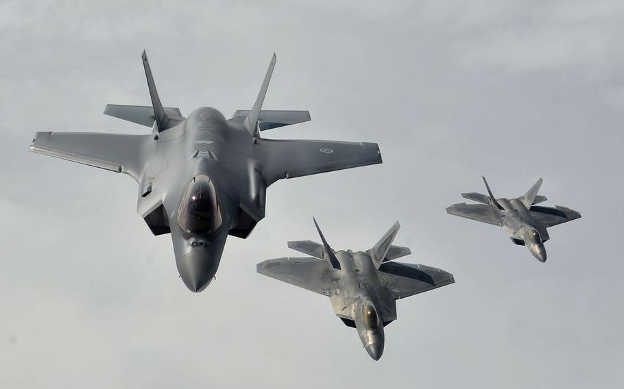 A Norwegian Air Force F-35, left, flies in formation with two U.S. Air Force F-22 Raptors over Norway, Wednesday, Aug. 15, 2018.