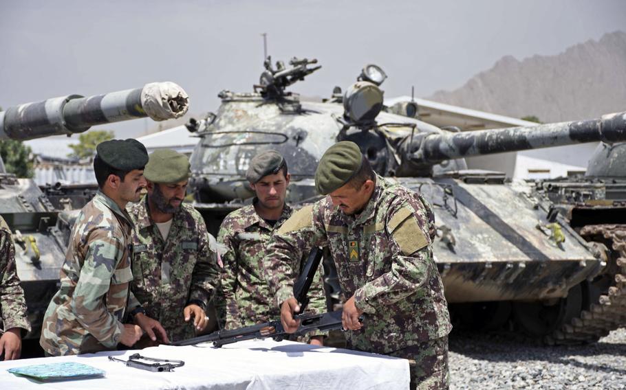 Soldiers of the 3rd Kandak, 2nd Brigade, 111th Capital Division, Afghanistan's lone tank battalion, learn to maintain a PK machine gun during training at an army base eastern outskirts of Kabul on Saturday, June 23, 2018. Officials say the tank battalion is struggling to keep its Soviet-made armor functional, while the troops are being tasked as infantry soldiers rather than tankers.