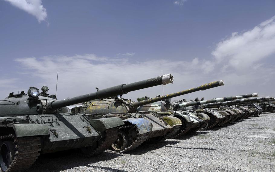 A row of T-55 and T-62 tanks with mismatched camoflauge patterns and rust spots stand in a lot at an Afghan army base on the eastern outskirts of Kabul on Saturday, June 23,2018.