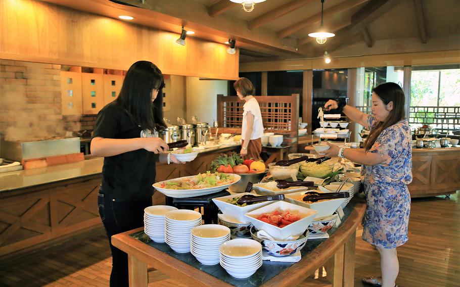 Diners at Makan Makan try the cold food station, which includes a salad bar and a make-your-own noodle bowl bar.