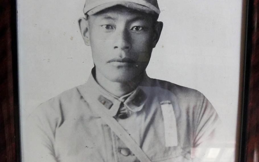 A framed photo of Japanese soldier Masamoto Abe, who died in New Guinea in 1944 at the age of 33.