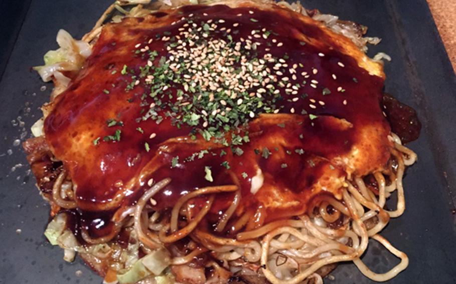 The Hiroshima-style okonomiyaki is the real star of the show at Okinawa City's Akai Helmet izakaya.
