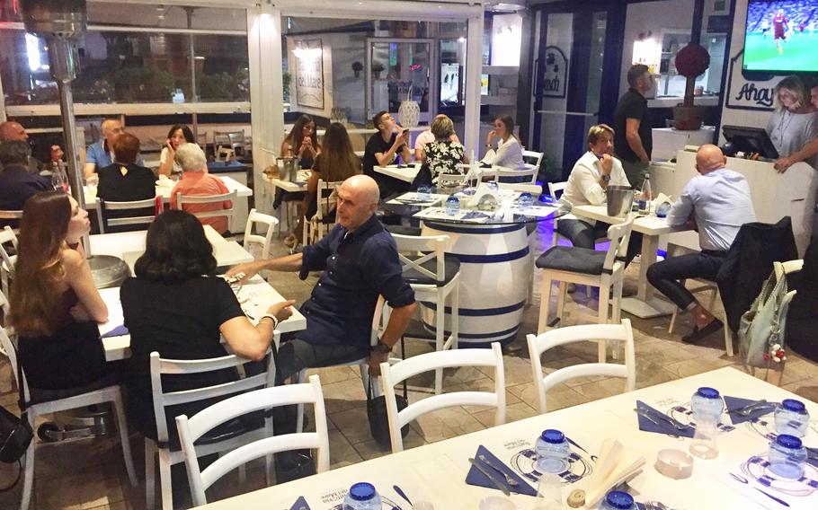Trattoria del Mare's covered patio is still busy at 10 on a week night in Pozzuoli, Italy. The restaurant serves a variety of seafood that is popular among local residents.