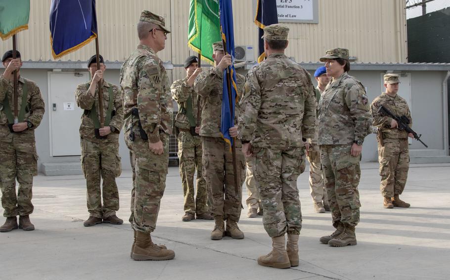 U.S. Army Maj. Gen. Robin Fontes,right, outgoing commander, Combined Security Transition Command - Afghanistan prepares to pass the CSTC-A guidon to U.S. Army Lt. Gen. James Rainey, left.