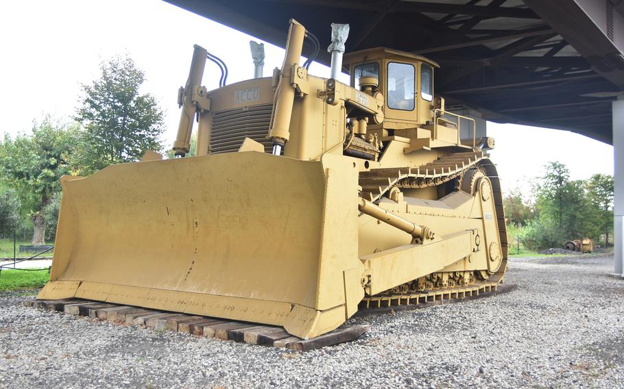 The Acco bulldozer, reportedly the largest such vehicle ever produced, sits at an underpass on the grounds of the Bejaflor gardening business in Portogruaro, Italy.
