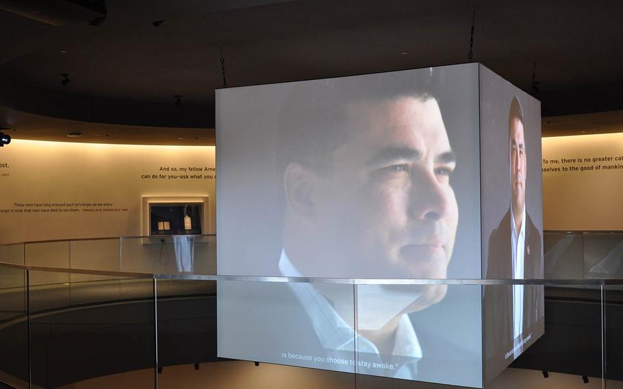 An interview with Jason Dominguez, a former Marine Corps sergeant, plays on large screens in the center of the National Veterans Memorial and Museum on Oct. 26. The facility opened Oct. 27 in Columbus, Ohio.