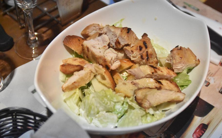The Chicken Caesar Salad at the Roadhouse includes a lot of chicken as well as lettuce, slices of Parmesan cheese and dressing.