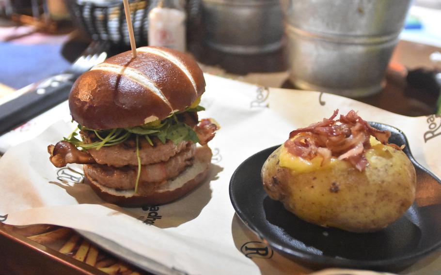 One of the sandwich options at the Roadhouse is the Double Pork. It features a pretzel-like bun, two pork patties, bacon, arugula, onions and a salsa. A baked potato (with cheese and bacon in this case) is available as a side.