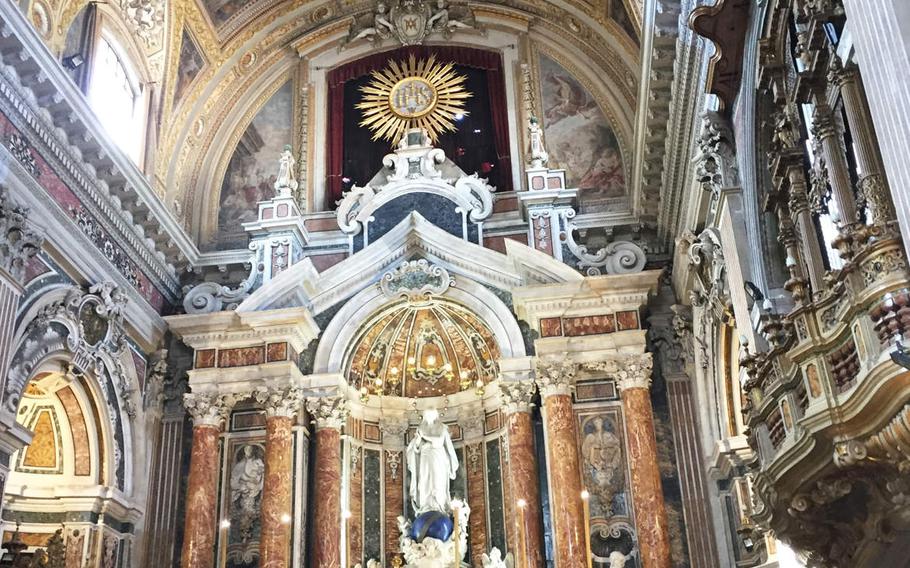 The main altar embodies the ornate art and architecture of the Church of Gesu Nuovo in Naples, Italy.