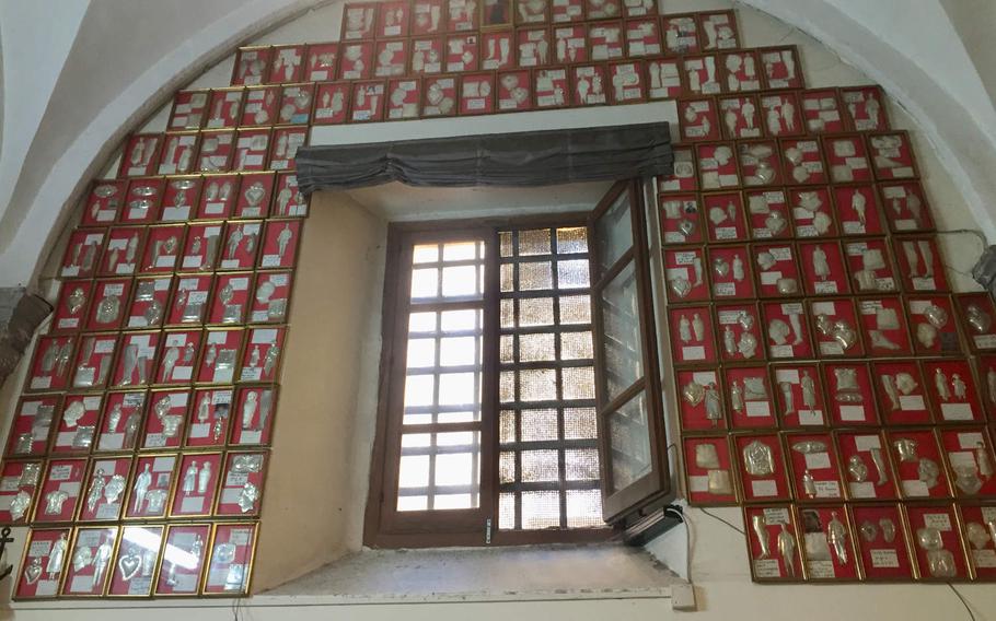 Within the church's Chapel of the Visitation are hundreds of testimonials from people claiming to have been healed by St. Guiseppe Moscati. The body parts that were healed are cast in silver on the red plaques.