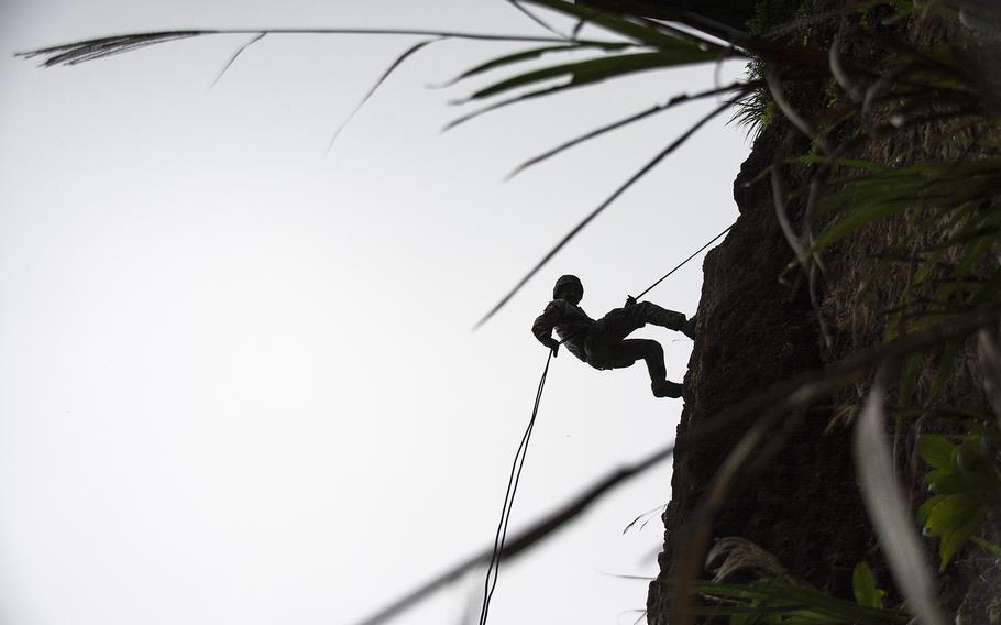 A Marine with the 9th Engineering Support Battalion rappels during an exercise at the Jungle Warfare Training Center, Okinawa, Dec. 4, 2018.