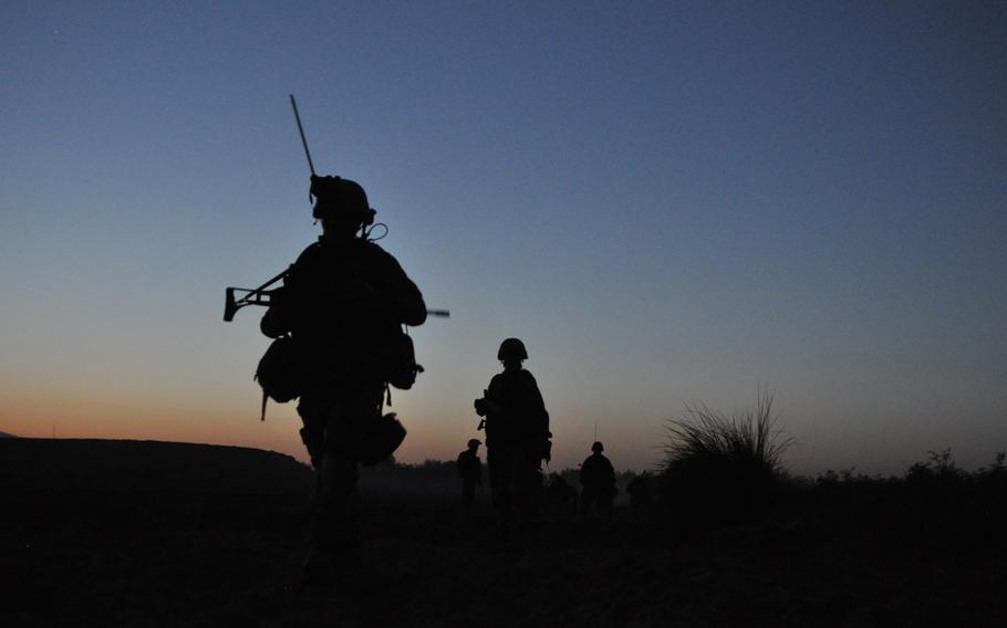 German soldiers finish a patrol at dusk in the Char Dara district, Kunduz province, Afghanistan.