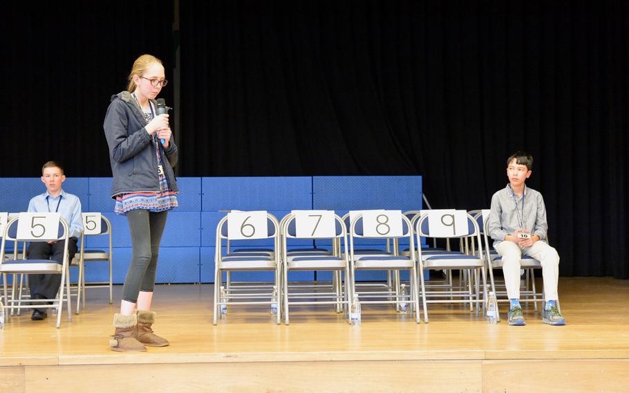 Asenath Wetzel, a student at Vicenza Middle School and one of the last of three competitors in the 2019 European PTA Regional Spelling Bee on Saturday Feb. 23, 2019, tries to spell "locution" in round 25 of the competition as fellow competitor Nicholas Biega looks on. 