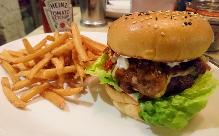 An order of the weekly burger creation at Bill's Restaurant in Bury St Edmunds, England, Feb. 26. The black bean chili burger had melted white cheese slathered over grilled chopped onions, a thick beef patty, lettuce and mildly spicy red peppers.