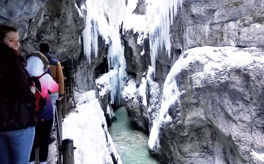 A group of tourists make their way down the Partnach Gorge, in Garmisch, Germany, in February, 2019.