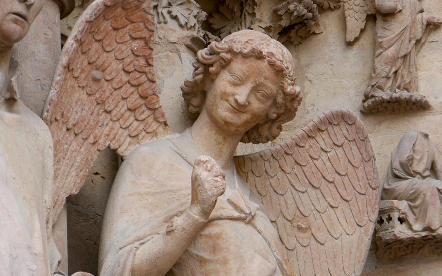 The smiling angel, one of 2,300 statues that decorate the Cathedral of Notre-Dame in Reims, France, inside and out.