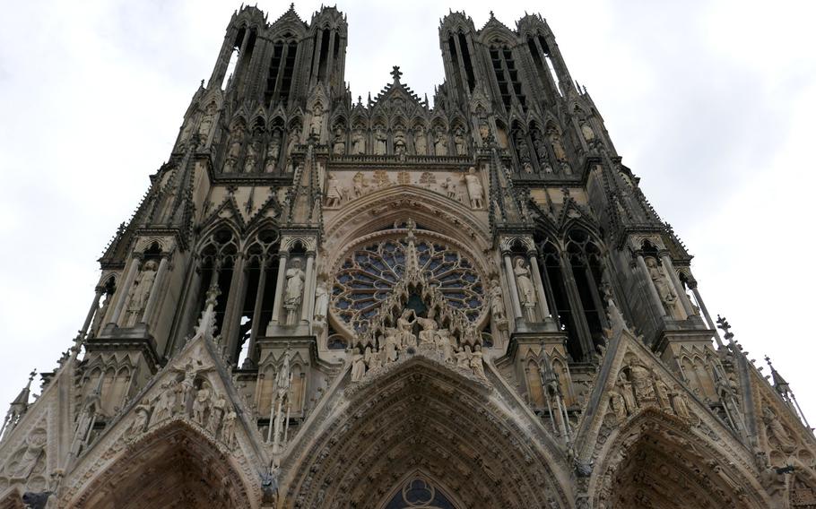 The west facade of the Cathedral of Notre-Dame in Reims, France. The cathedral is decorated, inside and out, with 2,300 statues of various sizes. Construction of the cathedral began in 1221 to replace an earlier edifice that was destroyed by fire.
