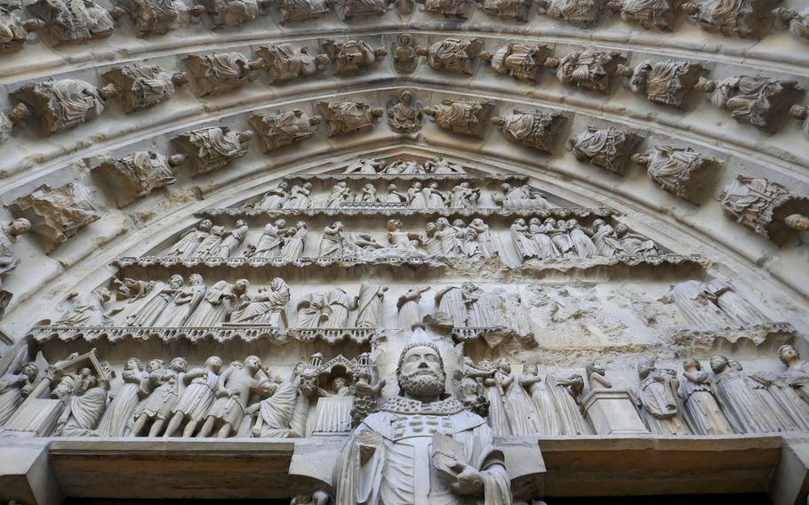 The richly adorned Cathedral of Notre-Dame in Reims, France. While there are kings, prophets bishops and saints decorating it, its most popular statues is that of a smiling angel.