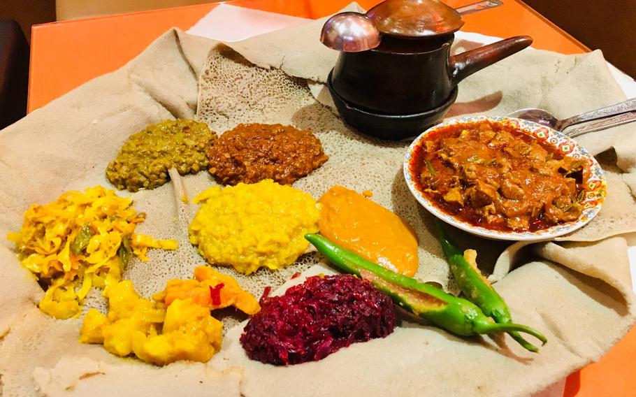An Ethiopian favorite called injera, a spongy-textured flatbread made of sourdough and served with various curries, can be found at many roadside eateries in Qudaibiya.