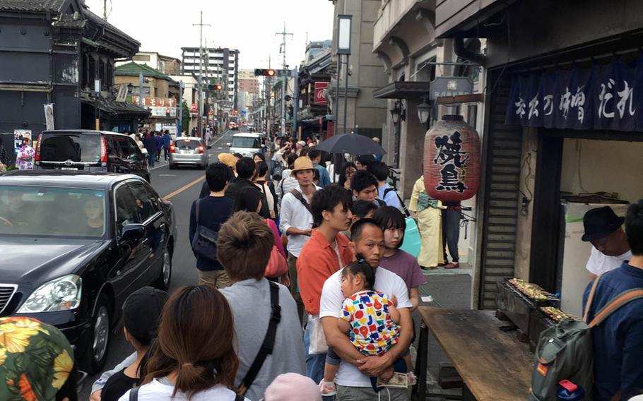 A line forms in Kurazukuri district of Kawagoe, Japan, for streetside yakitori, grilled chicken on skewers, on May 18, 2019.