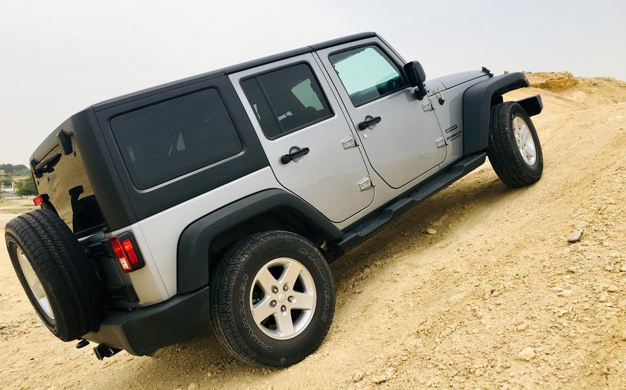 A 4X4 Jeep Wrangler navigates an off-road trail on a quiet day in the Southern Governate of Bahrain on May 11, 2019.