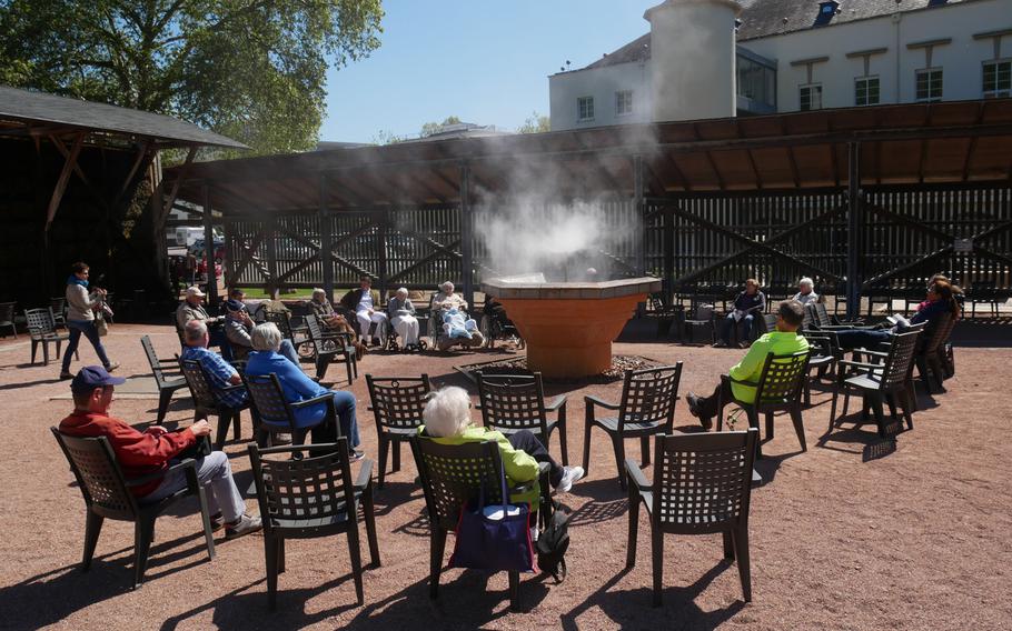 Visitors in the spa quarter of Bad Kreuznach, Germany, inhale the salty mist spewed from the fountain. The city is a popular spa town and salt was produced here for about two centuries.