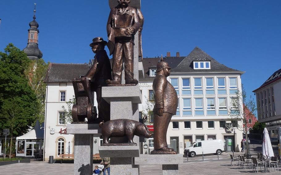 This statue on the Kornmarkt depicts well-known citizens and animals  of the town's past, topped by Marie Probeck, who alerted the townspeople with her horn when fire broke out. A market is held here every Tuesday and Thursday.