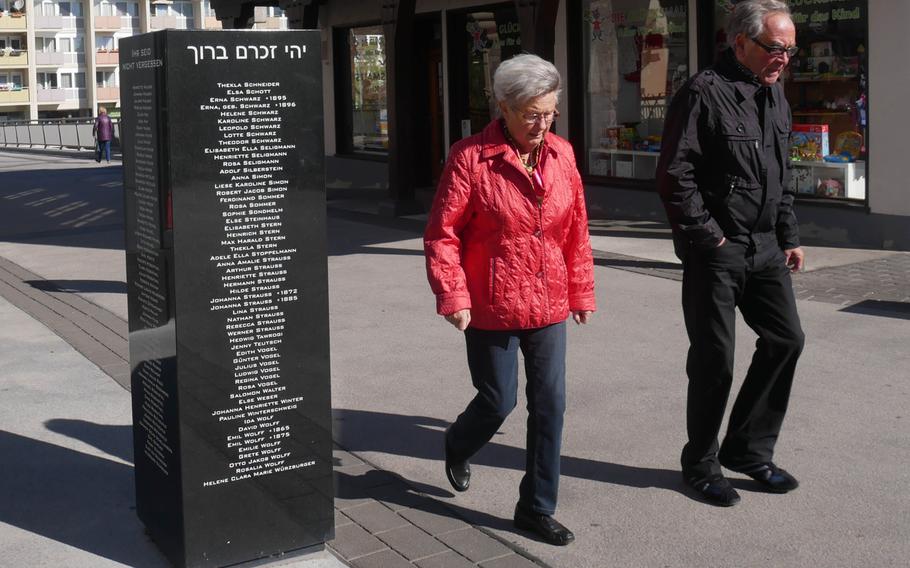 People walk past a Bad Kreuznach, Germany, monument that commemorates the city's Jews who were murdered by the Nazis.
